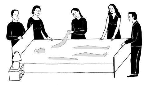 Black and white ethereal illustration of five people around a bed with one person lying in it, holding the hand of one of the people around it