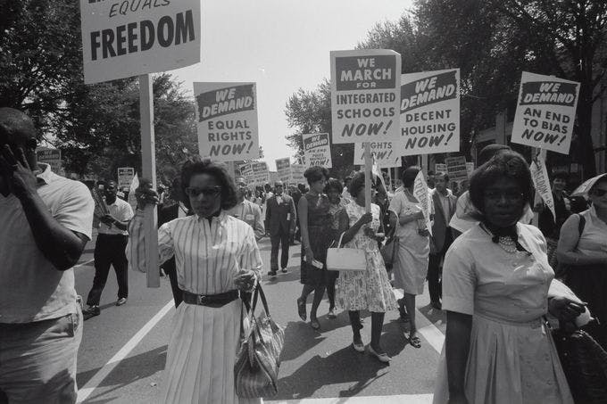Civil rights march on Washington, D.C. Film negative by photographer Warren K. Leffler, 1963. From the U.S. News & World Report Collection. Library of Congress Prints & Photographs Division.     Photograph shows a procession of African Americans carrying signs for equal rights, integrated schools, decent housing, and an end to bias.